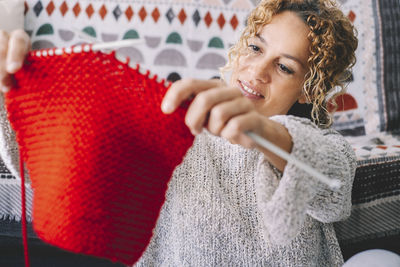 Woman crocheting at home