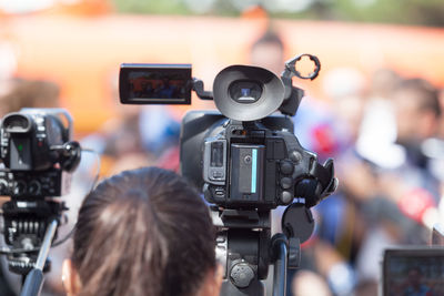 Rear view of operator with camera during event