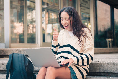 Young woman talking on video call through laptop