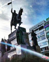 Low angle view of statue against cloudy sky