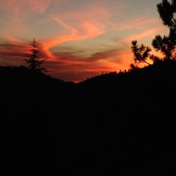 Scenic view of silhouette mountains against sky at sunset