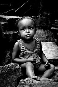 Portrait of young man sitting on bench