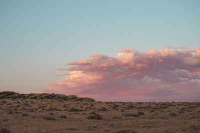 Scenic view of desert against sky during sunset