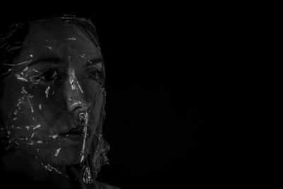 Close-up of frozen water against black background