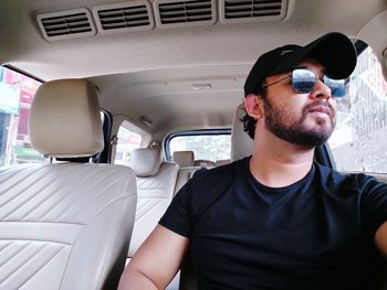 Portrait of man sitting in car