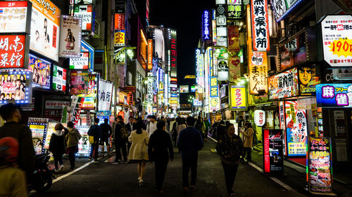 Crowd in illuminated city at night