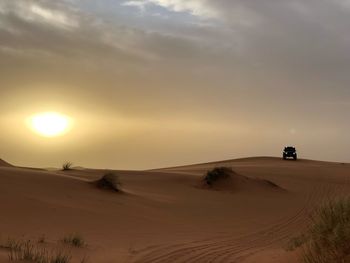 Scenic view of desert against sky during sunset