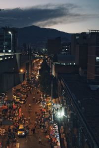 High angle view of illuminated city against sky at night