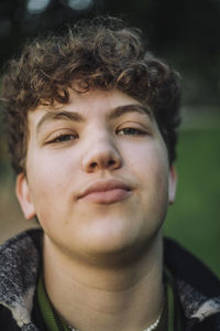 Portrait of smiling teenage boy with curly hair