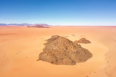 Scenic view of desert against clear sky