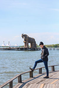 Full length of man standing on pier against sky