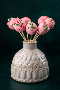 Close-up of pink roses on table against black background