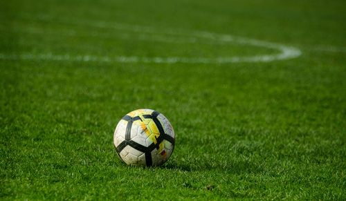 Close-up of soccer ball on field