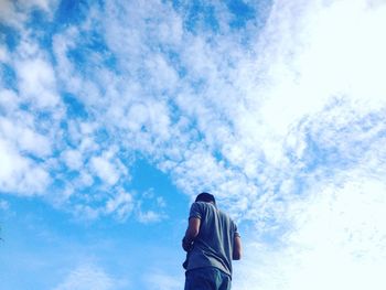 Low angle view of person standing against sky