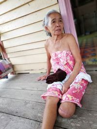 Full length of woman sitting outdoors