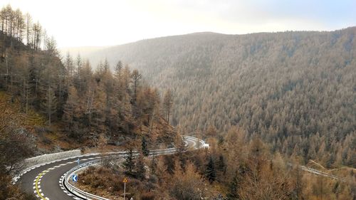 High angle view of road amidst trees against sky