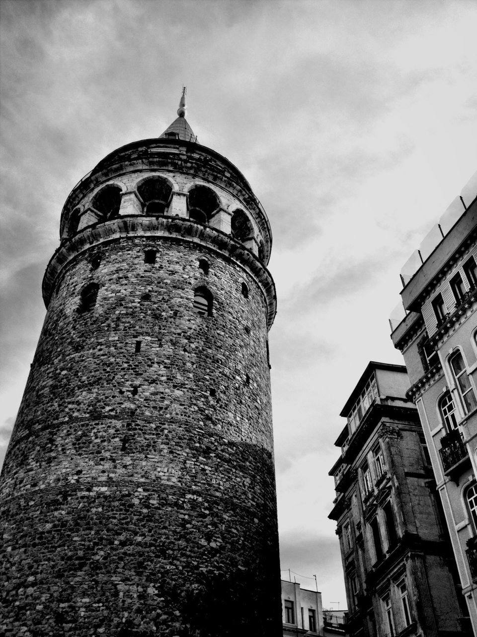 LOW ANGLE VIEW OF TOWER AGAINST CLOUDY SKY