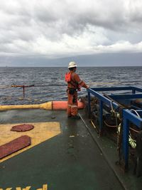 Side view of worker standing at offshore platform