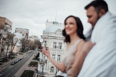 Couple embracing by railing in balcony