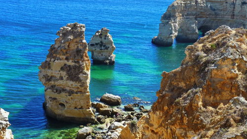 High angle view of rocks on sea shore