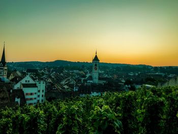 View of townscape against clear sky at sunset