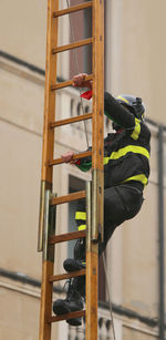 Brave firefighter over a wooden stairs during a fire-fighting exercise