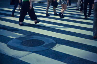 Low section of people walking on street