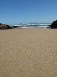 Scenic view of beach against clear sky