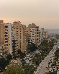 High angle view of street amidst buildings against sky