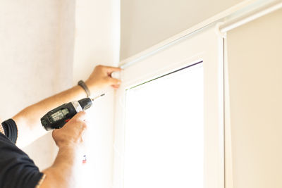 Cropped hand of man holding knife