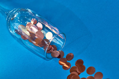 High angle view of woman ball on glass against blue background