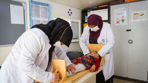 Doctor examines child malnutrition. 