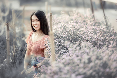 Portrait of a smiling young woman standing outdoors