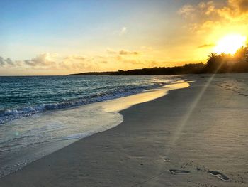 Scenic view of beach against sky during sunset