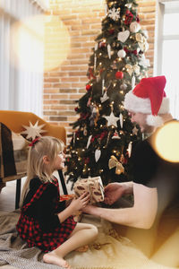 Woman with christmas tree at home