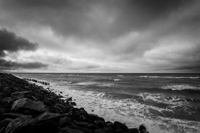 Scenic view of sea against cloudy sky