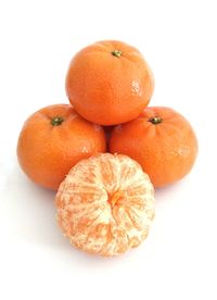 Close-up of orange eggs against white background