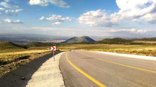 Empty road passing through country road