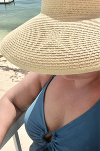Rear view of woman sitting on beach