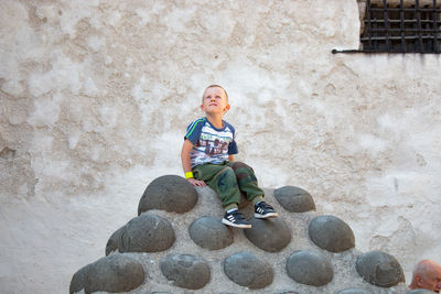 Portrait of smiling boy sitting outdoors