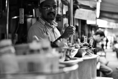 Portrait of male vendor selling street food