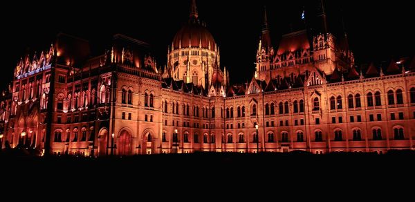 Low angle view of illuminated buildings at night