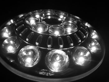 Close-up of illuminated lamp over black background