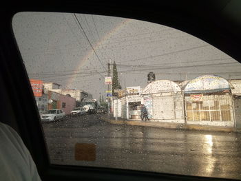 Buildings seen through wet window during rainy season