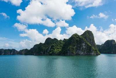 Scenic view of sea and mountains against sky