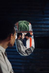 Rear view of couple standing on the wall