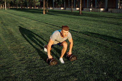 Full length of boy playing in lawn