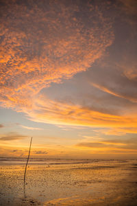 Scenic view of beach against sky during sunset