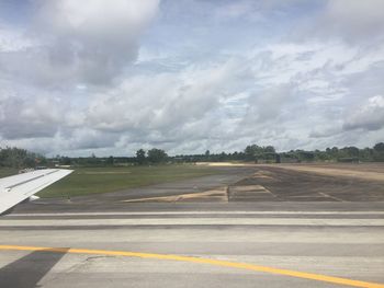 Airplane on runway against sky