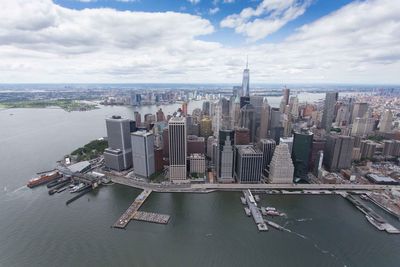 High angle view of modern buildings against cloudy sky